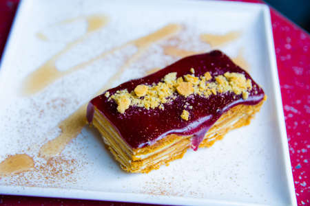 sweet dessert cake sprinkled with nuts.