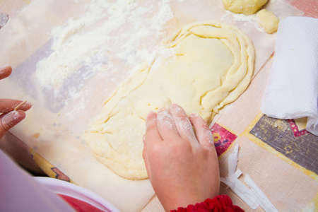 the child cooks a pie with meat