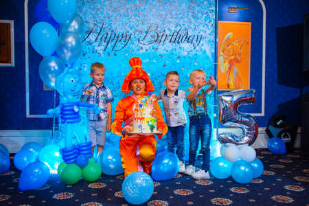 Alchevsk, Ukraine - September 14, 2020: children with an animator play in a cafe. blow out the candles on the cakeのeditorial素材