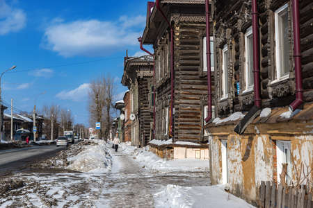 Tomsk, Russia - March 12, 2021. Wooden residential buildings on the street of the old district of Tomskのeditorial素材