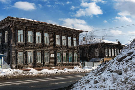 Tomsk, Russia - March 12, 2021. Wooden residential buildings on the street of the old district of Tomskのeditorial素材