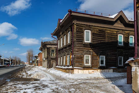 Tomsk, Russia - March 12, 2021. Wooden residential buildings on the street of the old district of Tomskのeditorial素材