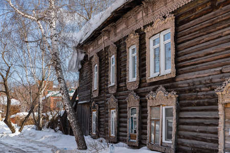 Tomsk, Russia - March 12, 2021. Wooden residential building on the street of the old district of Tomskのeditorial素材