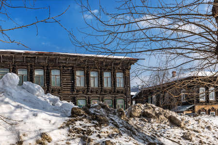 Tomsk, Russia - March 12, 2021. Wooden residential buildings on the street of the old district of Tomskのeditorial素材