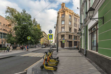 Moscow. Russia - August 8, 2021. Yandex Go scooters in front of the Federal Treasury building on Bolshoy Zlatoustinsky Laneのeditorial素材