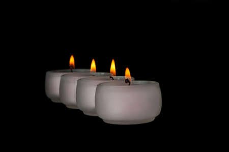 Beautiful candles burning on a black backgroundの写真素材