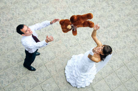 bride and groom fun and play. Throw up teddy bearの写真素材