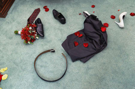 wedding night  disrobed wedding clothes  straggle objects  Shues, suit, bouquet, belt, necktie and rose petalの写真素材