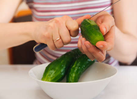 Woman cutting to peel cucumbers  Kitchen working  Prepare foodの写真素材