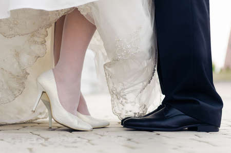 wedding shoes of bride and groom. face to face standingの写真素材