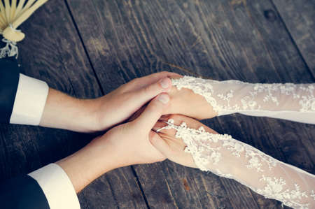 Hand in hands of wedding couple. togetherness couple and loving careの写真素材