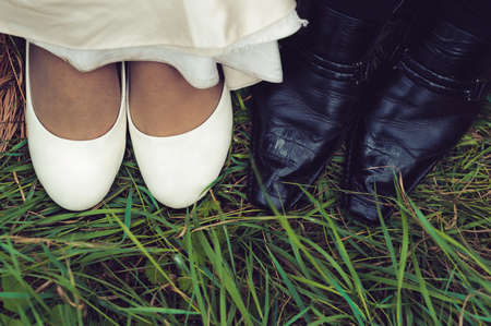wedding shoes of bride and groom in a green grass. close-up wedding shoesの写真素材