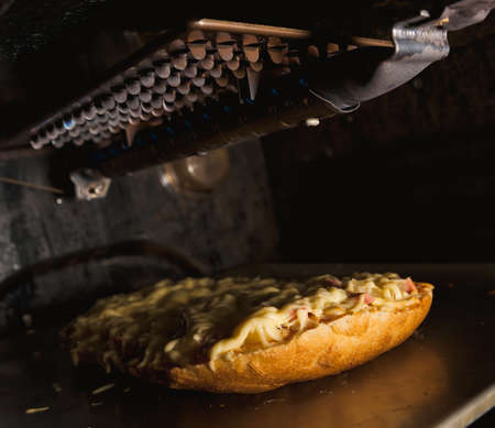 cooking cheese pizza in a hot ovenの写真素材