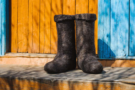 rural old felt boots standing on a porchの写真素材
