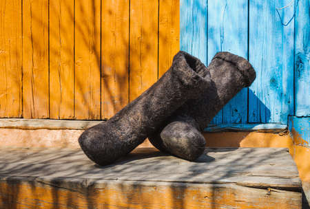 rural old felt boots standing on a porchの写真素材