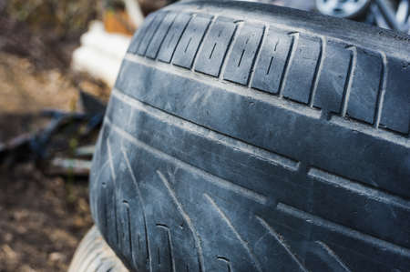 old tyre with worn tread. selective focus technique. blur backgroundsの写真素材