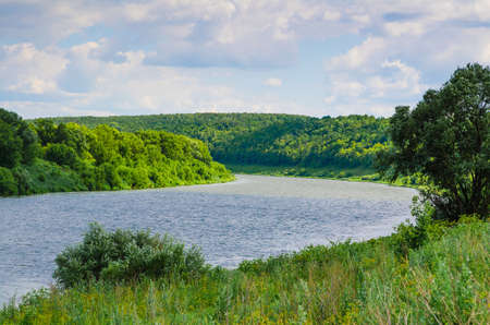 stream river flows on green dale. landscape viewの写真素材