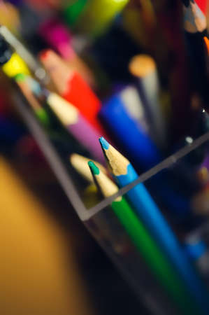 many multicolored pencils in a box. Selective focus on a tip of blue pencilの写真素材