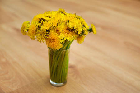 bunch of flowers. Yellow summer dandelions bouquet in a bowlの写真素材