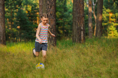 girl playing in soccer on nature backgroundsの写真素材