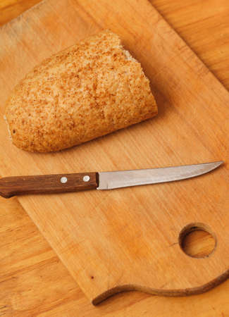 rye bread and knife lying on tableの写真素材