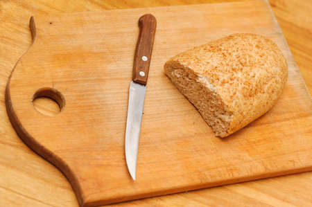rye bread and knife lying on table. selective focus techniqueの写真素材