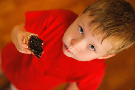 kid eating tasty bread with bilberry jamの写真素材