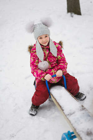 smile girl sitting on teeter-totterの写真素材