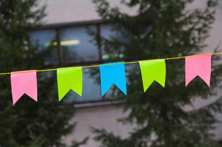 multicolored small flag of paper on a ropeの写真素材