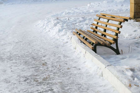 old bench on a snow winter backgroundsの写真素材