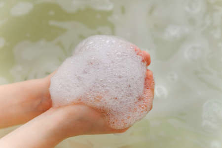 white soap foam with bubble in a handsの写真素材