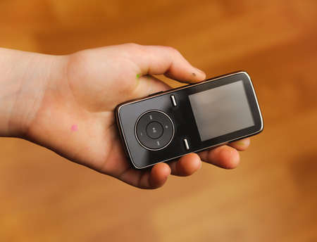 multimedia player in a kids hand on blur backgroundsの写真素材