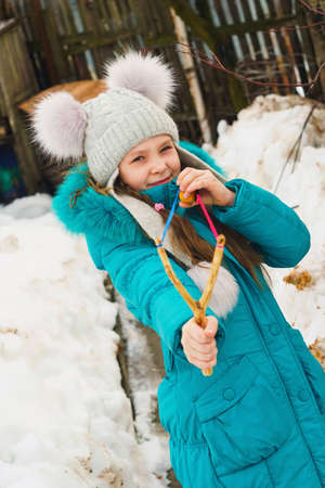 girl aiming of slingshotの写真素材