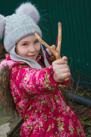 girl aiming of slingshotの写真素材