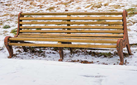 old bench on a snow winter backgroundの写真素材