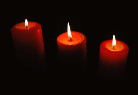 Beautiful candles burning on black backgroundsの写真素材