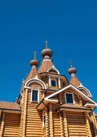 old orthodox wooden church on clear blue sky backgroundsの写真素材