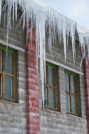 big icicles hanging on a roofの写真素材