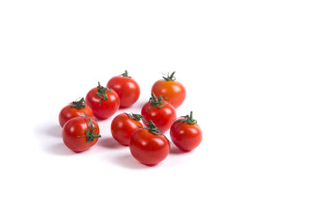 Several cherry tomatoes without a sprig on a white surfaceの写真素材