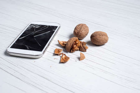 phone with broken glass and the walnuts