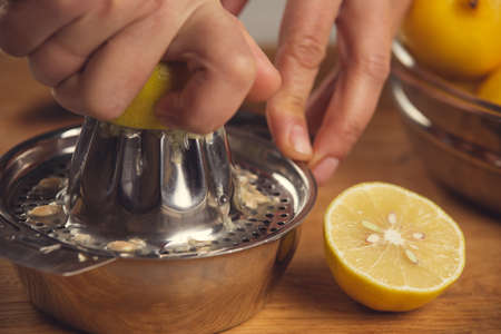 Fine art still life with orange juice and porcelain juicer on wooden tableの写真素材