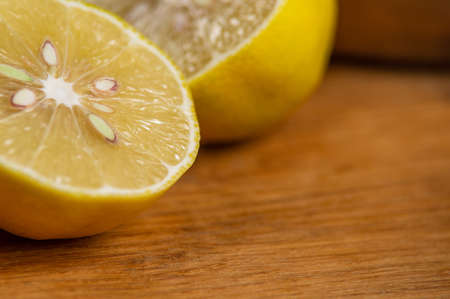 Still life with yellow lemon halves on a wooden tableの写真素材