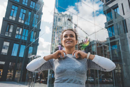 Smiling girl on the background of glass buildingsの写真素材