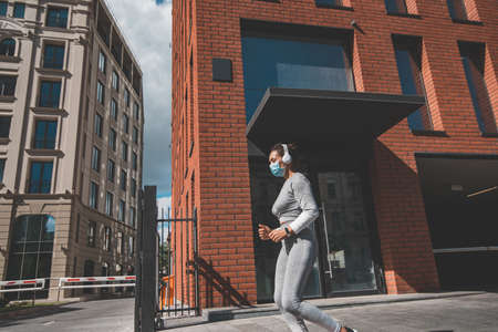 A woman running down a city streetの写真素材
