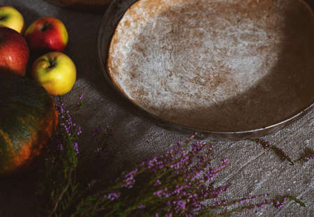 Preparation, Thanksgiving Day celebration. Concept. Side view of a pan with pie dough, next to...