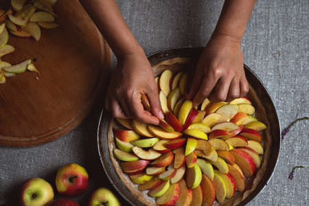Preparation, Thanksgiving Day celebration. A chef finishes adding apples to the pie. Making a traditional apple pie.の写真素材