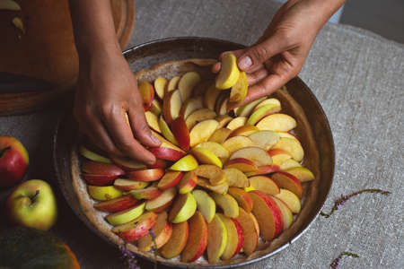Preparation, Thanksgiving Day celebration. A chef finishes adding apples to the pie. Making a traditional apple pie.の写真素材