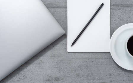 Flat lay of the office space overlooking laptop notebook with pencil and cup of coffee.の写真素材