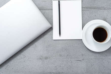Flat lay of the office space overlooking laptop notebook with pencil and cup of coffee.の写真素材