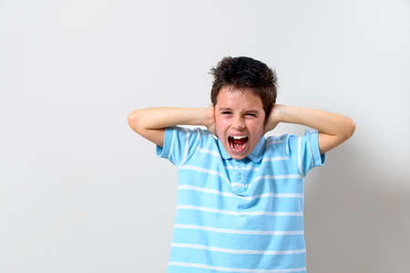 Boy in the blue T-shirt covered his hands and shouted.の写真素材